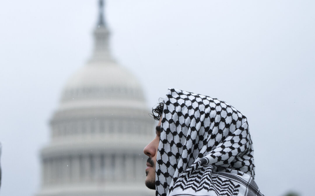 Hundreds of pro-Palestinian protesters rally in the rain in DC to mark a painful present and past